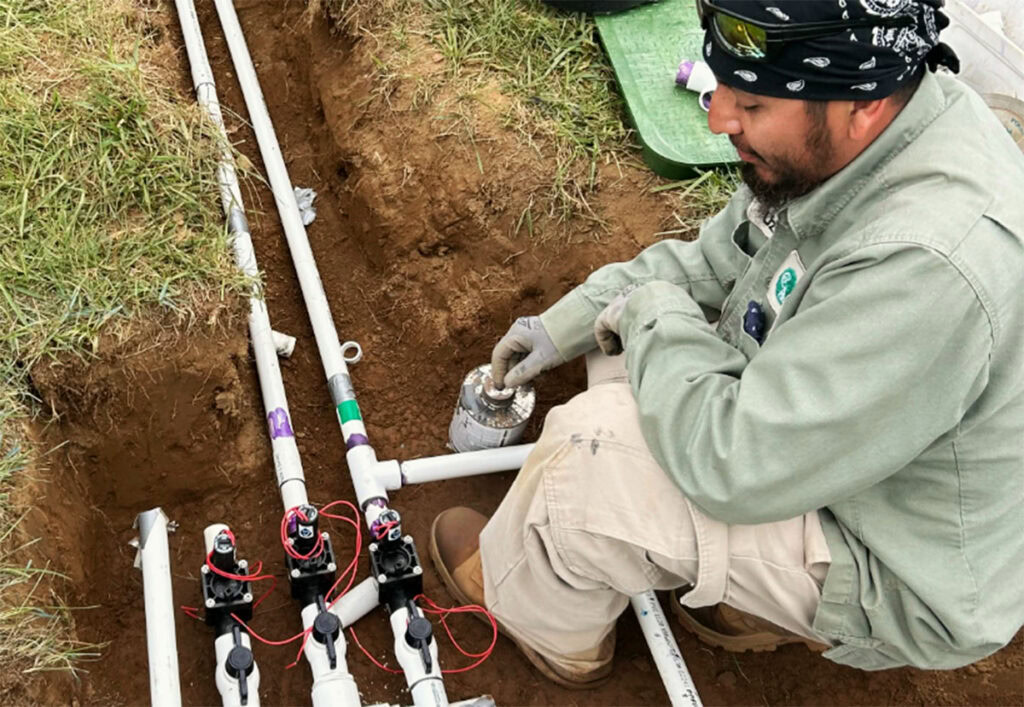 Creation Appreciation Team Member configuring an irrigation system.