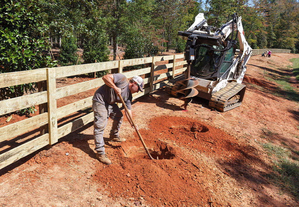 Creation Appreciation planting trees along a fence